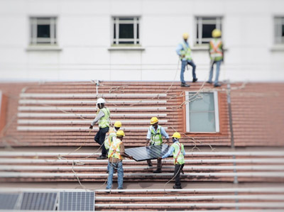 Solar panel workers on roof